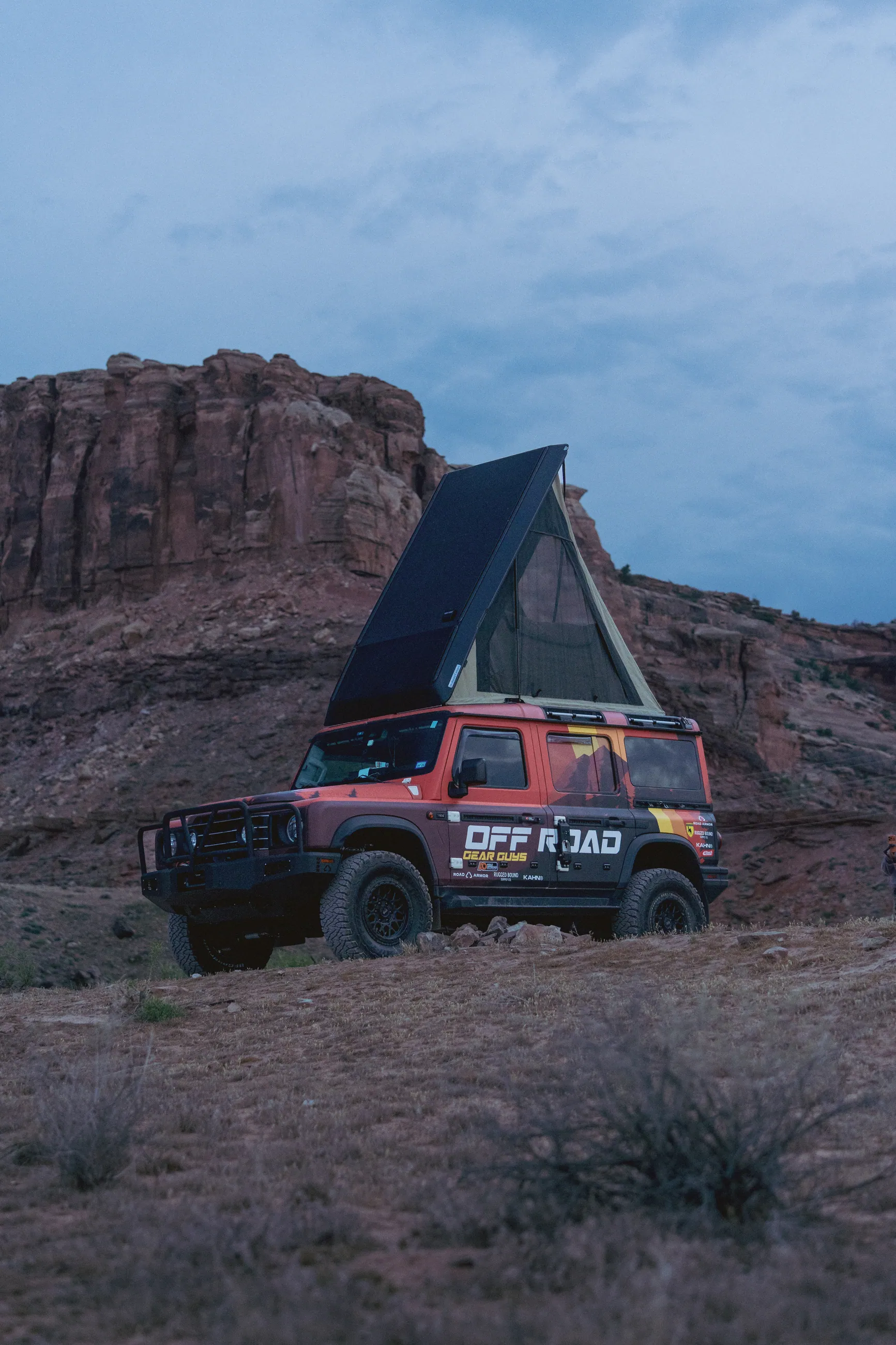 The Off Road Gear Guys Grenadier with its rooftop tent open at dusk