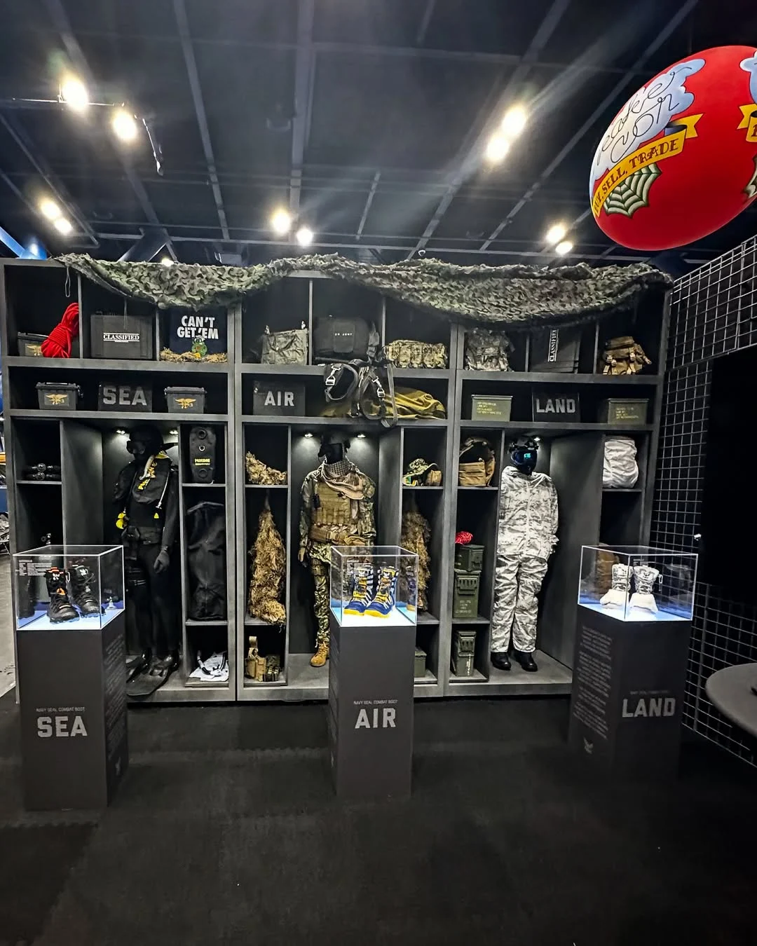 The Navy activation at Sneaker Con: SEAL gear lockers with the Sea, Air, and Land boots in display cases